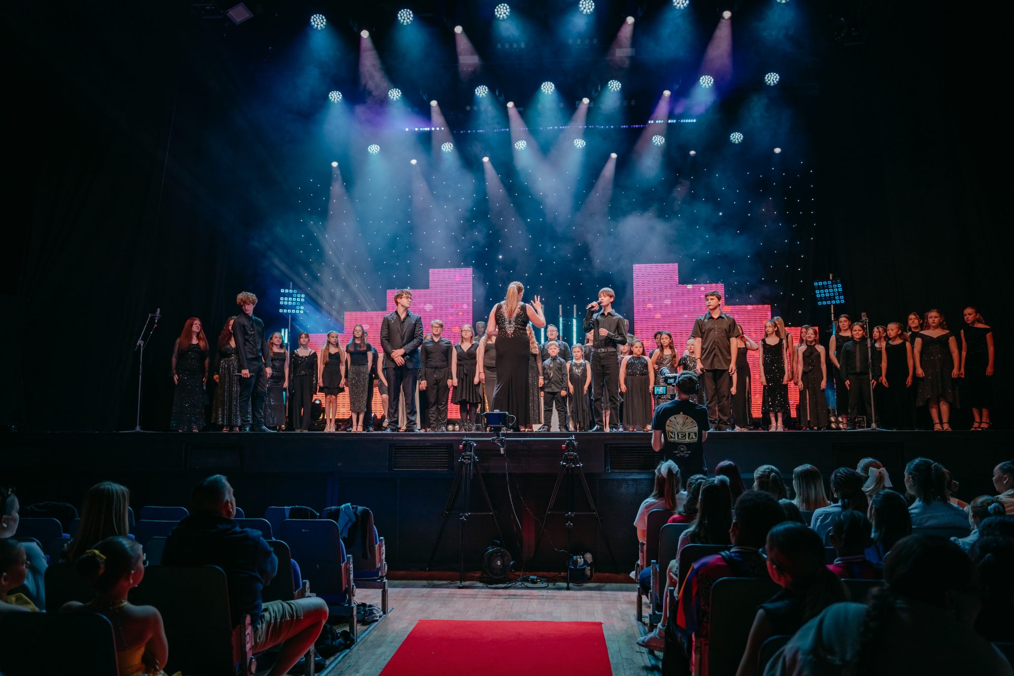 Voice Junction choir performing on stage at The O2, London